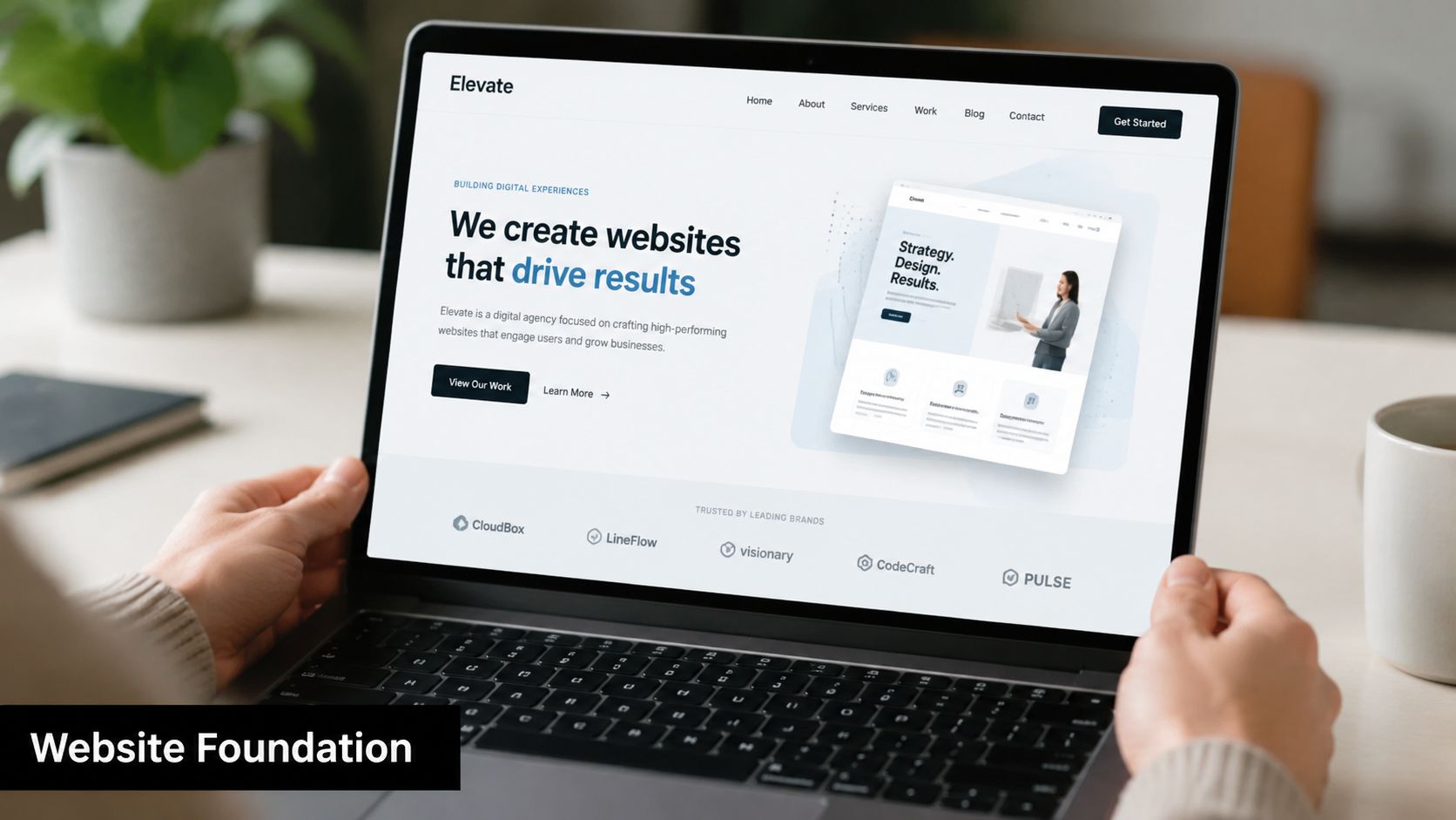 A person using a laptop displaying a modern professional website design for a digital agency service.