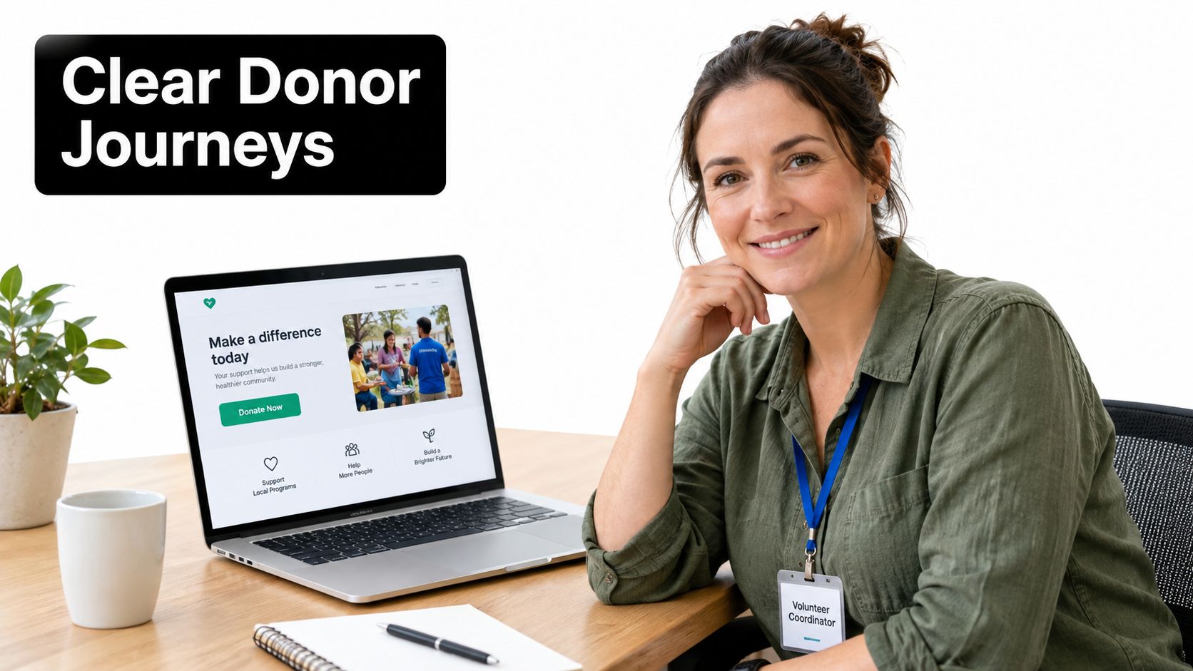 A smiling volunteer coordinator sitting at a desk with a laptop displaying a non-profit donation website.